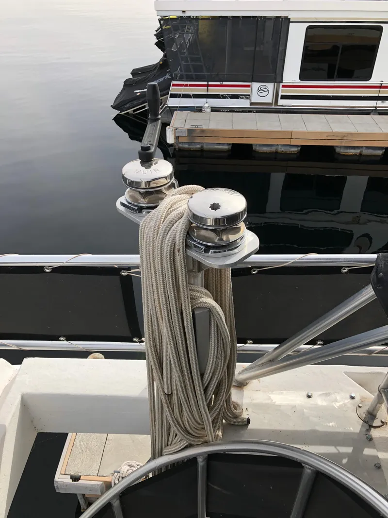 Slide: The Image of Sailboat winches with ropes on a Custom Endless Summer 2001, docked near a houseboat. - 5