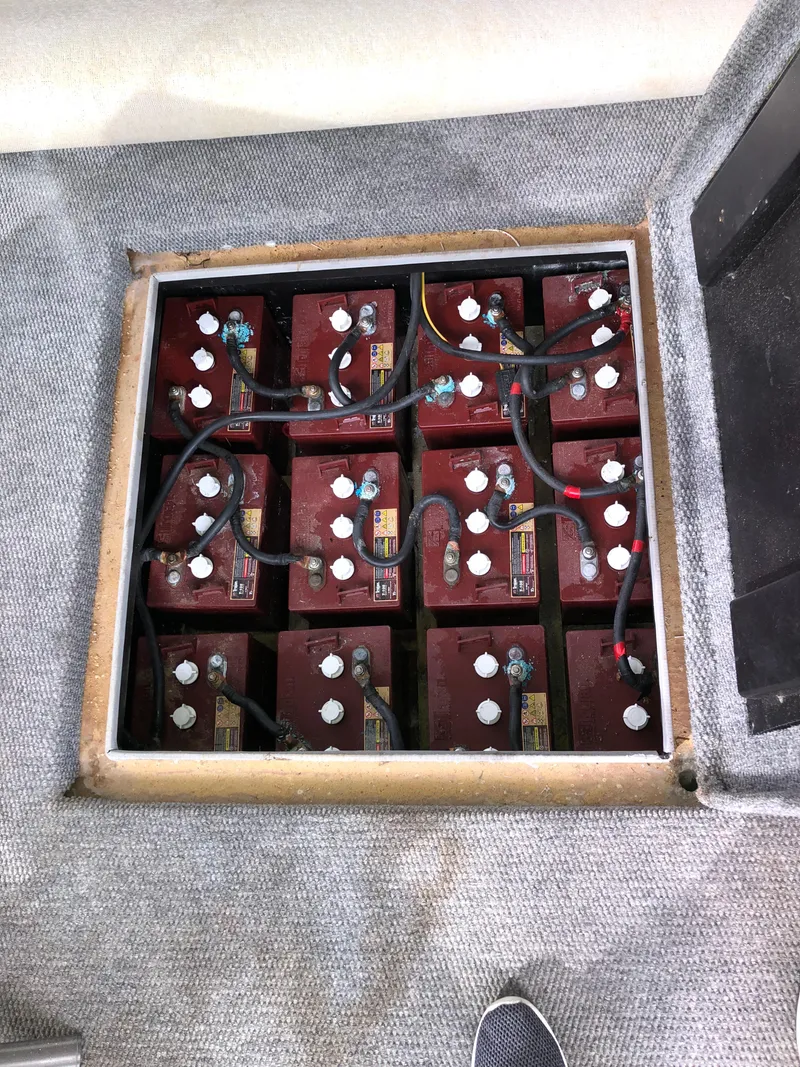 Slide: The Image of Battery compartment of a 2001 Custom Endless Summer vehicle, featuring multiple red batteries. - 8