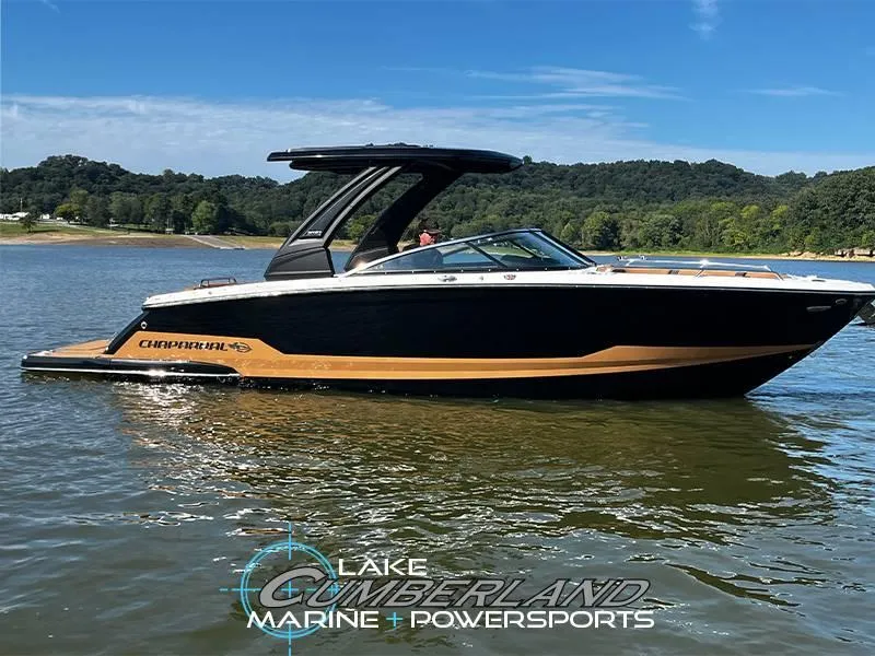 Slide: The Image of 2025 Chaparral 287 SSX boat on Lake Cumberland, sleek design, black and gold accents. - 1