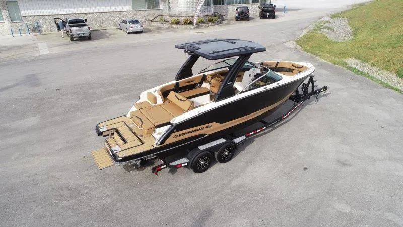Slide: The Image of 2025 Chaparral 287 SSX boat on trailer, parked outdoors. - 11