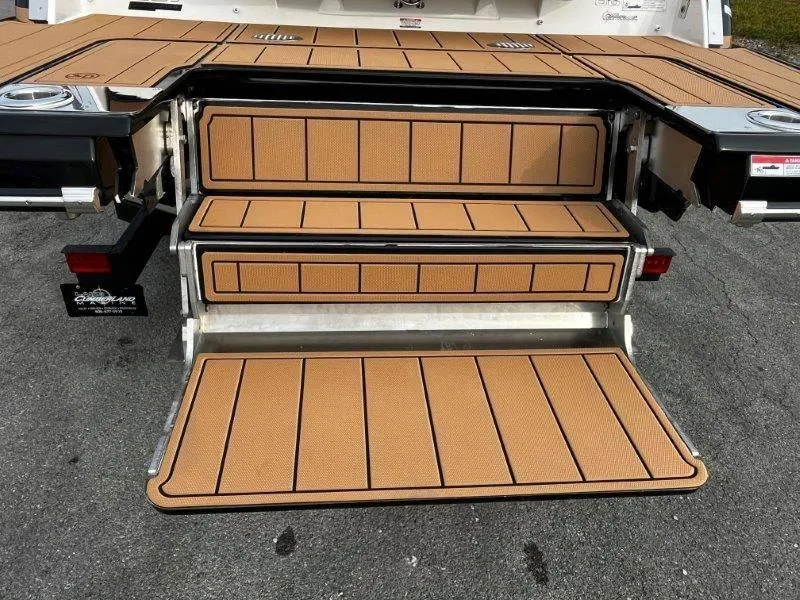 Slide: The Image of 2025 Chaparral 287 SSX boat with tan deck steps and swim platform. - 19