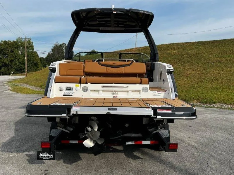 Slide: The Image of 2025 Chaparral 287 SSX boat rear view with tan seating and swim platform. - 30