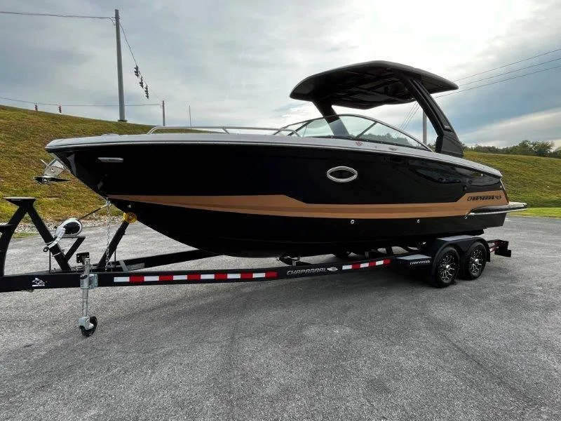 Slide: The Image of 2025 Chaparral 287 SSX boat on trailer, sleek black design, parked outdoors. - 36