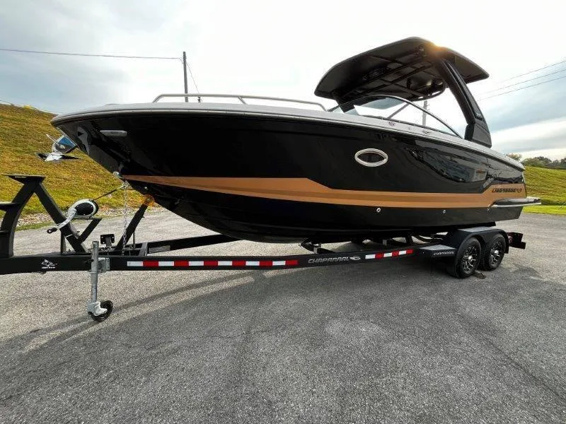 Slide: The Image of 2025 Chaparral 287 SSX boat on trailer, sleek black and gold design. - 37