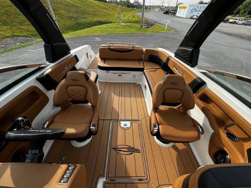 Slide: The Image of 2025 Chaparral 287 SSX boat interior with tan leather seats and sleek design. - 41