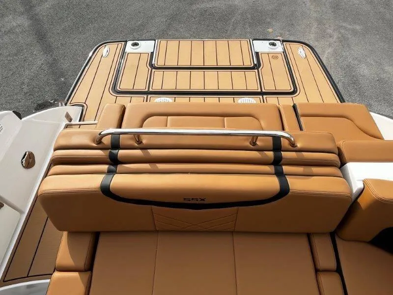 Slide: The Image of 2025 Chaparral 287 SSX boat with tan leather seating and sleek deck design. - 44