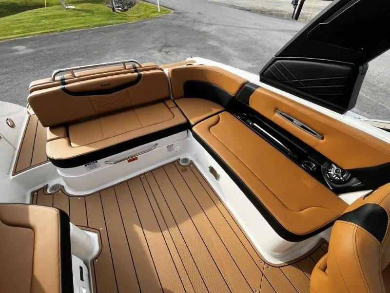 Slide: The Image of 2025 Chaparral 287 SSX boat interior with tan leather seating and wood flooring. - 45