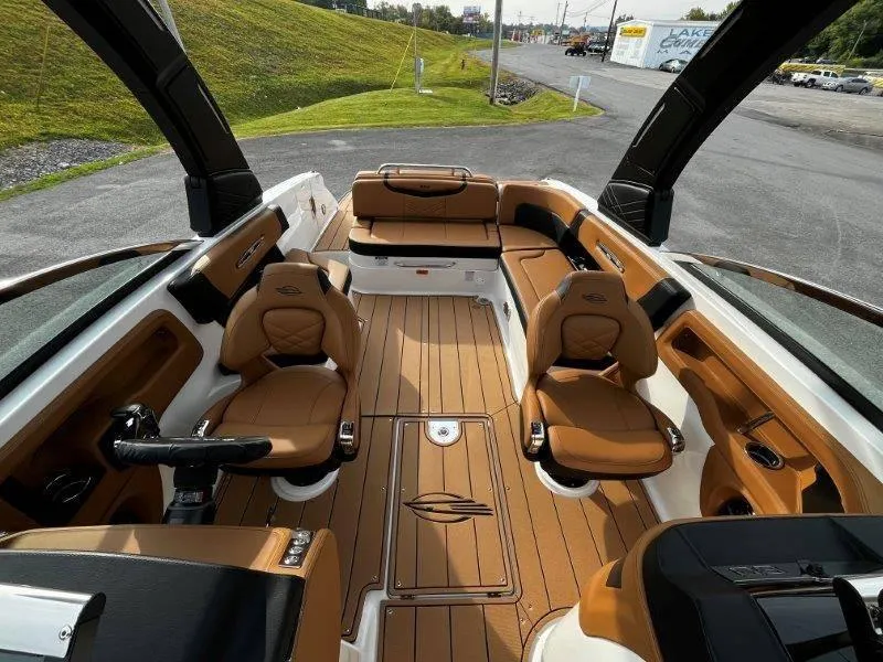 Slide: The Image of 2025 Chaparral 287 SSX boat interior with luxurious tan seating and sleek design. - 46