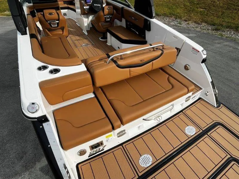 Slide: The Image of 2025 Chaparral 287 SSX boat interior with luxurious tan seating and sleek design. - 47