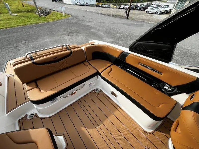 Slide: The Image of 2025 Chaparral 287 SSX boat interior with tan leather seating and sleek design. - 49