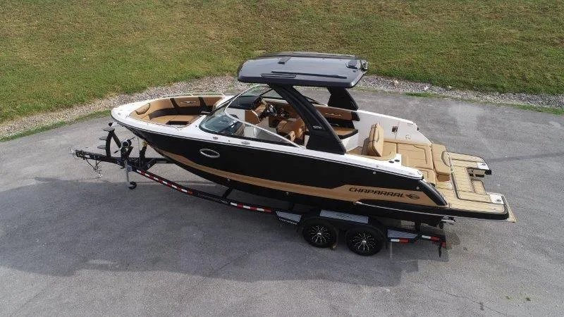 Slide: The Image of 2025 Chaparral 287 SSX boat on trailer, sleek design, black and tan exterior. - 5