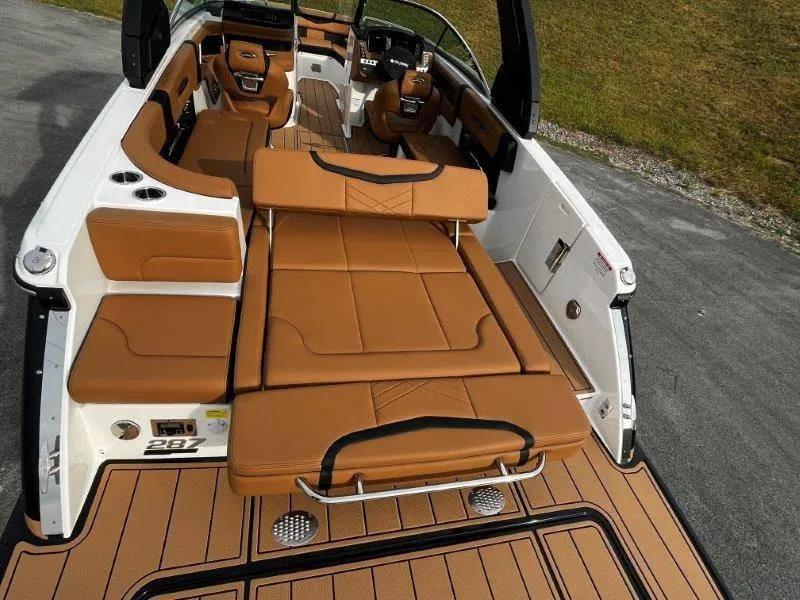 Slide: The Image of 2025 Chaparral 287 SSX boat interior with tan leather seating and sleek design. - 50
