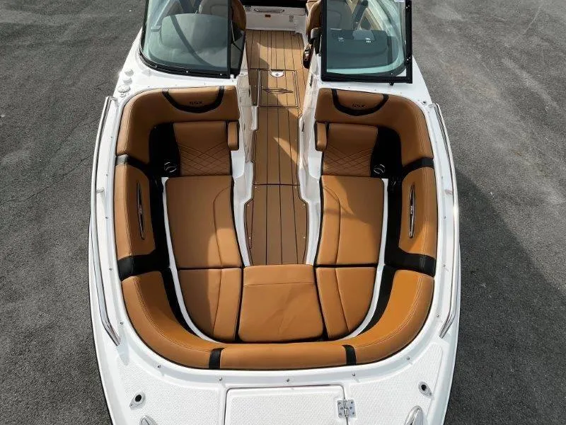 Slide: The Image of 2025 Chaparral 287 SSX boat interior with tan leather seating and open cockpit. - 52