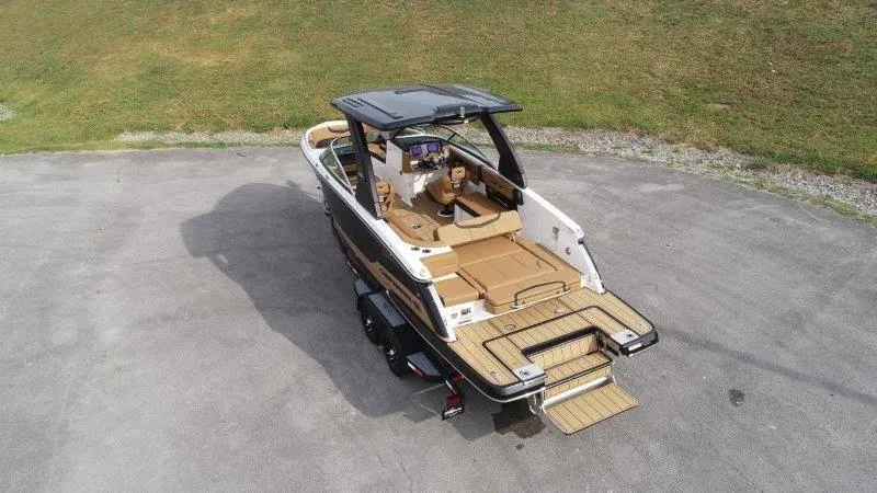 Slide: The Image of 2025 Chaparral 287 SSX boat on trailer, aerial view, sleek design. - 9
