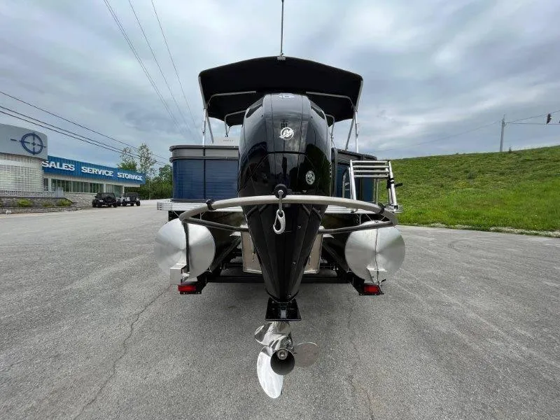 Slide: The Image of 2023 Crest Classic Fish 220 SF boat, rear view, parked near sales and service center. - 13