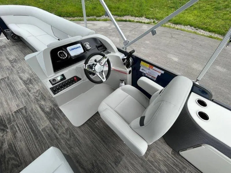 Slide: The Image of 2023 Crest Classic Fish 220 SF boat interior with steering console and seating. - 18