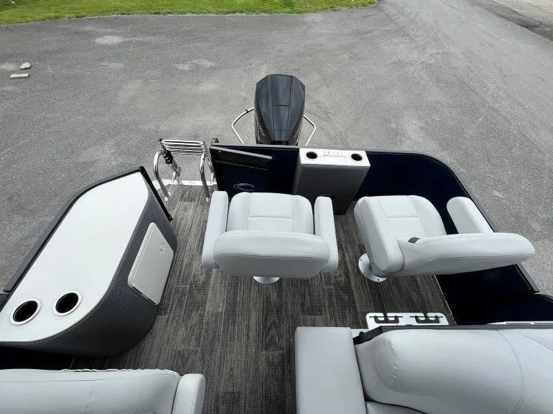 Slide: The Image of 2023 Crest Classic Fish 220 SF boat interior with seating and motor view. - 24