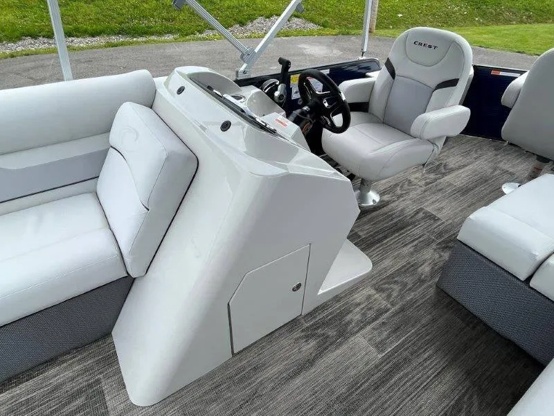 Slide: The Image of 2023 Crest Classic Fish 220 SF boat interior with modern seating and steering console. - 29