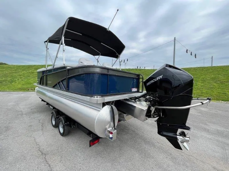 Slide: The Image of 2023 Crest Classic Fish 220 SF pontoon boat with Mercury engine on trailer. - 3