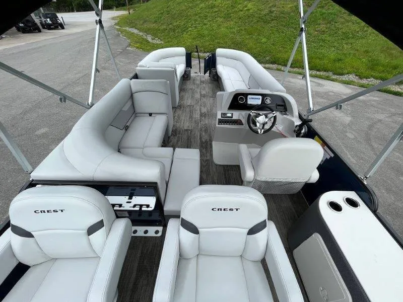Slide: The Image of 2023 Crest Classic Fish 220 SF pontoon boat interior with plush seating and modern dashboard. - 36