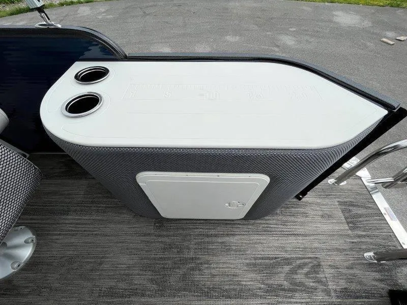 Slide: The Image of 2023 Crest Classic Fish 220 SF boat with integrated cup holders and storage compartment. - 38