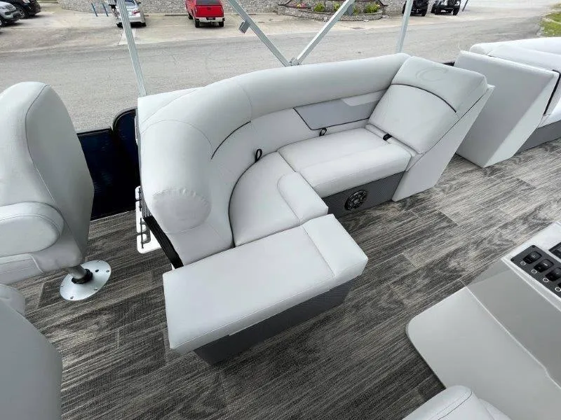Slide: The Image of 2023 Crest Classic Fish 220 SF boat interior with gray seating and wood-style flooring. - 39