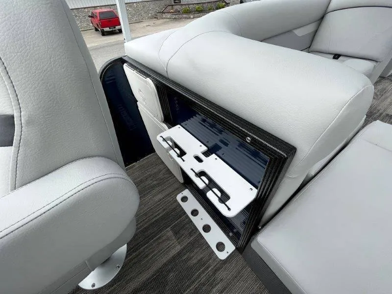 Slide: The Image of 2023 Crest Classic Fish 220 SF boat interior with storage compartment and seating. - 44
