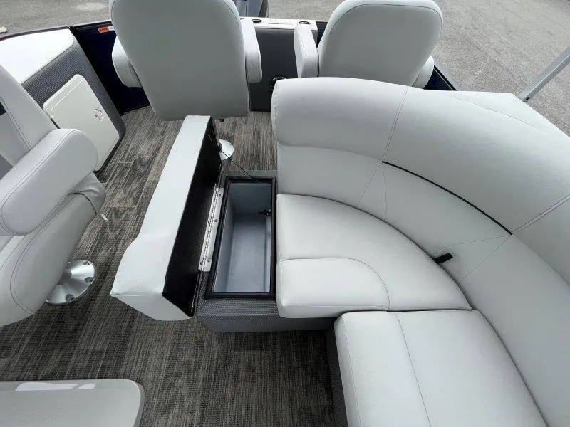 Slide: The Image of 2023 Crest Classic Fish 220 SF boat interior with white seating and storage compartment. - 45