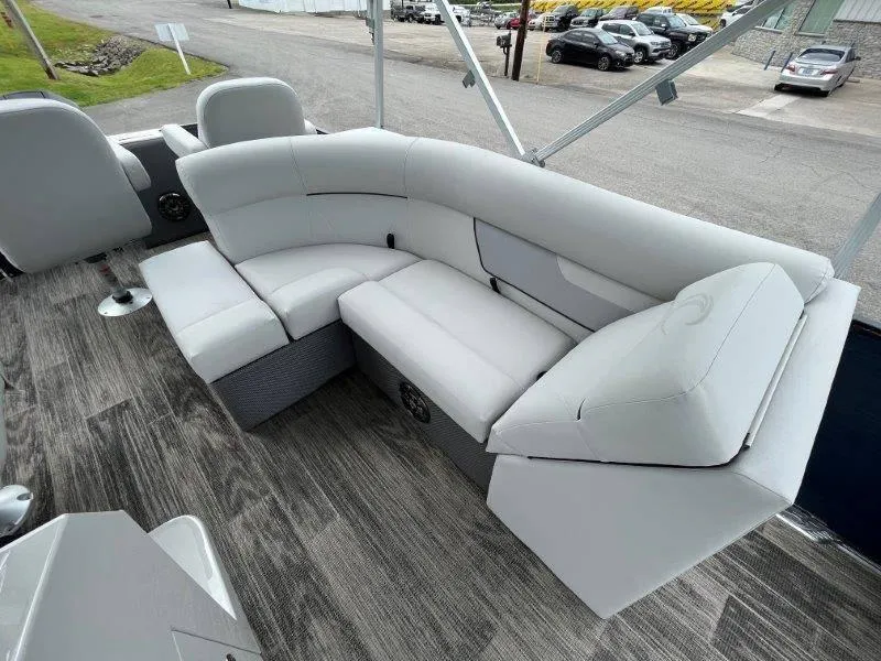 Slide: The Image of 2023 Crest Classic Fish 220 SF boat interior with plush gray seating and wood-style flooring. - 46