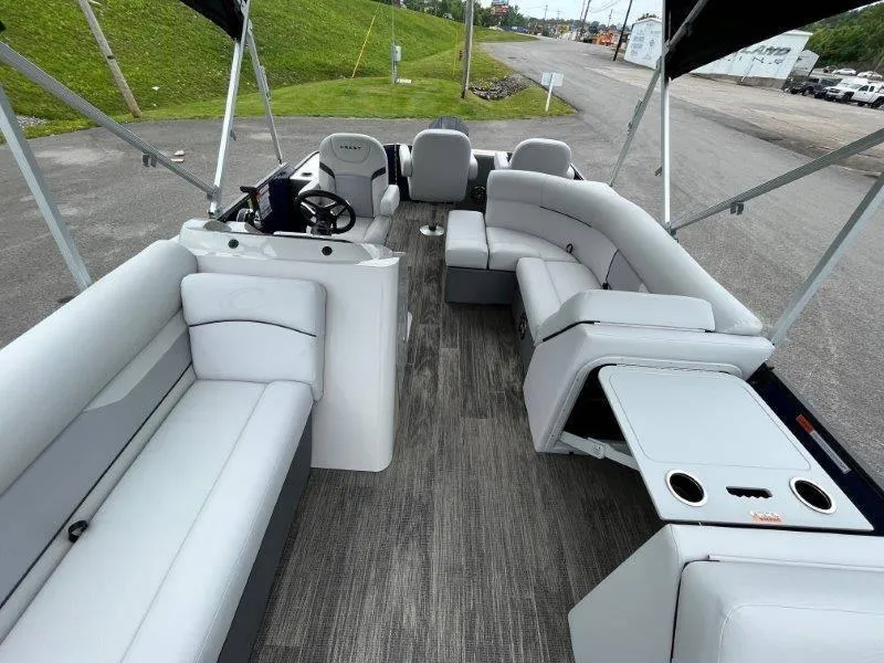 Slide: The Image of 2023 Crest Classic Fish 220 SF pontoon boat interior with gray seating and wood-style flooring. - 48