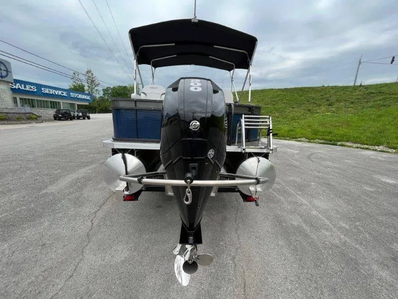 Slide: The Image of 2023 Crest Classic Fish 220 SF pontoon boat with outboard motor, parked outdoors. - 9