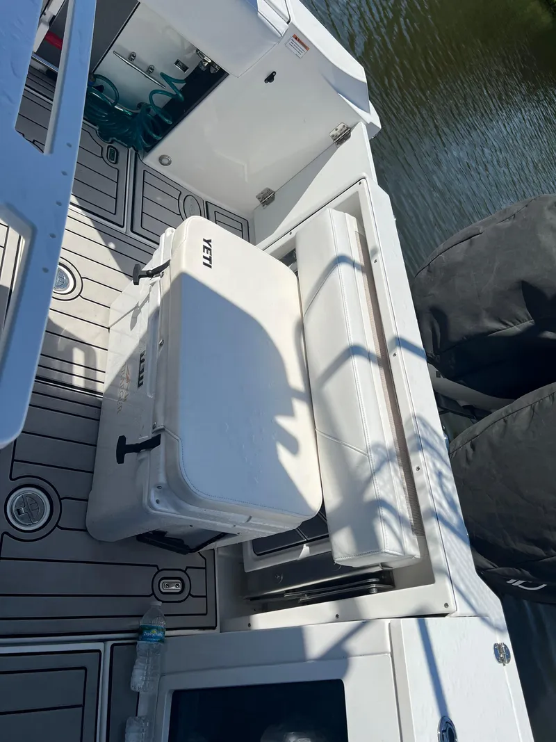 Slide: The Image of 2020 Blackfin 272 CC boat deck with Yeti cooler and twin engines. - 11