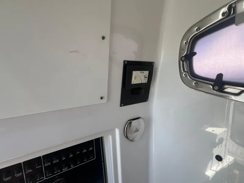 Slide: The Image of Interior view of a 2020 Blackfin 272 CC boat, featuring control panel and window. - 16