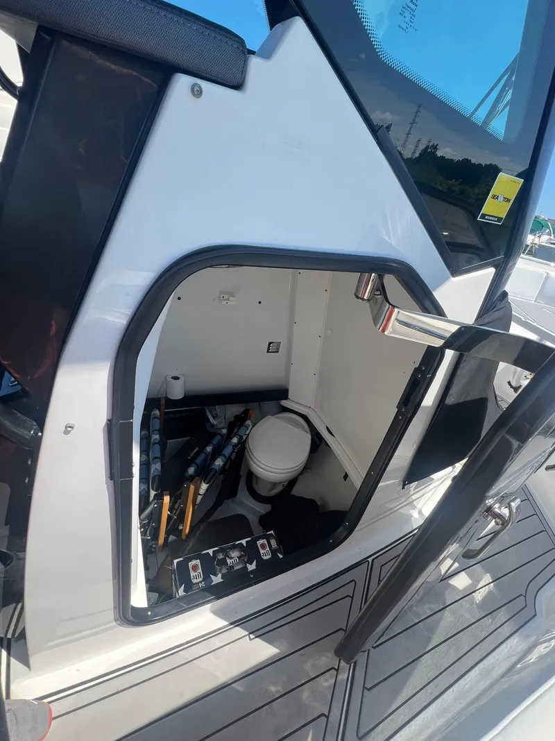 Slide: The Image of 2020 Blackfin 272 CC boat interior with storage compartment and toilet. - 17