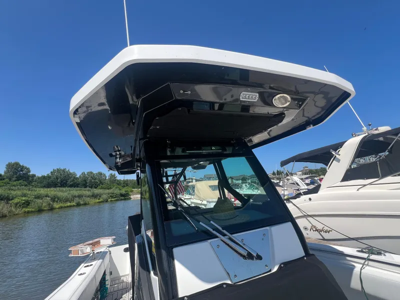 Slide: The Image of 2020 Blackfin 272 CC boat docked, featuring sleek design and modern canopy. - 19