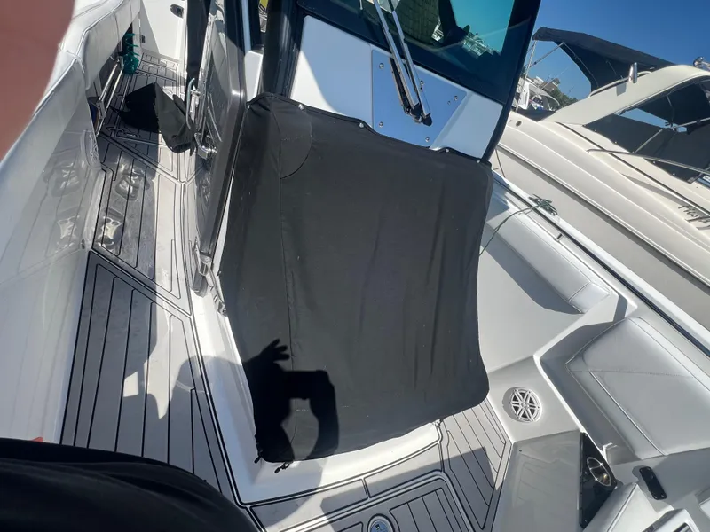 Slide: The Image of 2020 Blackfin 272 CC boat interior with covered console and seating area. - 20