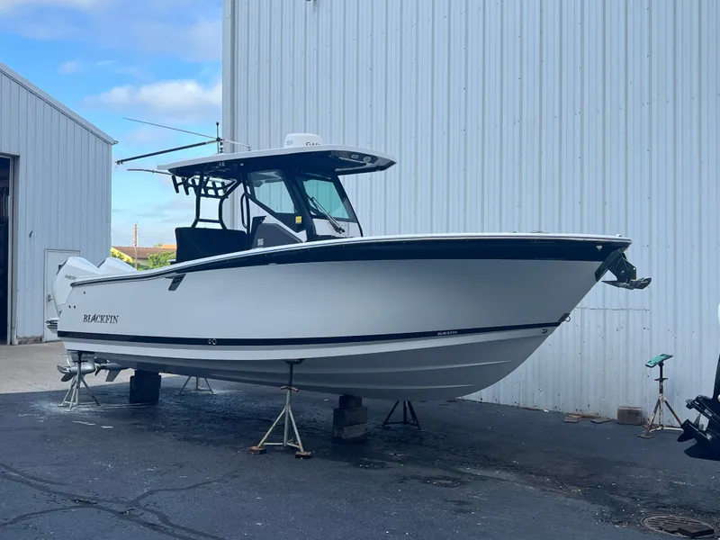Slide: The Image of 2020 Blackfin 272 CC boat on stands outside a warehouse. - 27