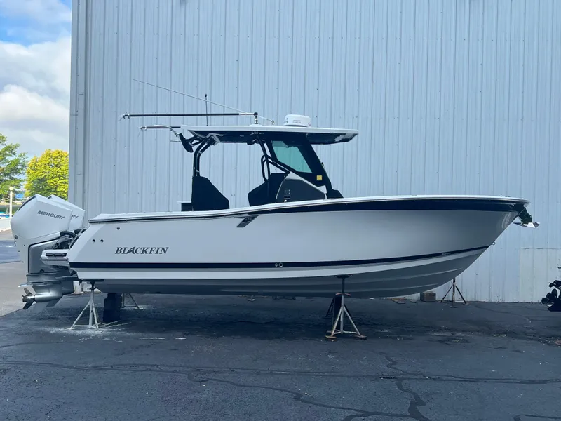 Slide: The Image of 2020 Blackfin 272 CC boat on stands, side view against a white wall. - 28