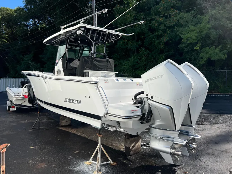 Slide: The Image of 2020 Blackfin 272 CC boat with dual Mercury engines on display outdoors. - 3
