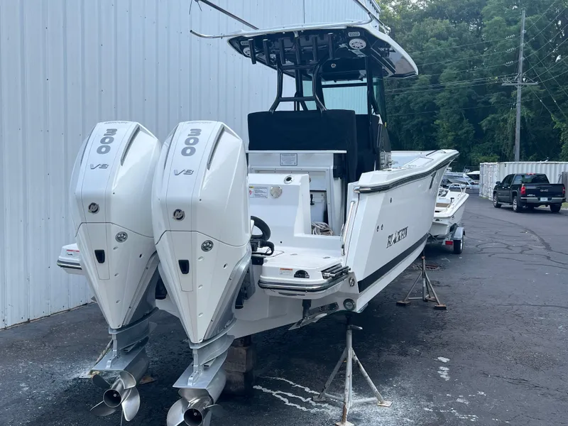 Slide: The Image of 2020 Blackfin 272 CC boat with twin 300 V8 engines, parked outdoors. - 31