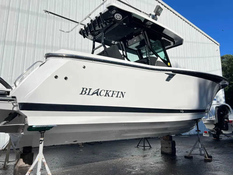 Slide: The Image of 2020 Blackfin 272 CC boat on stands, white exterior, outdoor setting. - 33