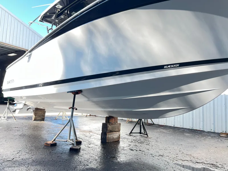 Slide: The Image of 2020 Blackfin 272 CC boat on stands in a marina setting. - 34