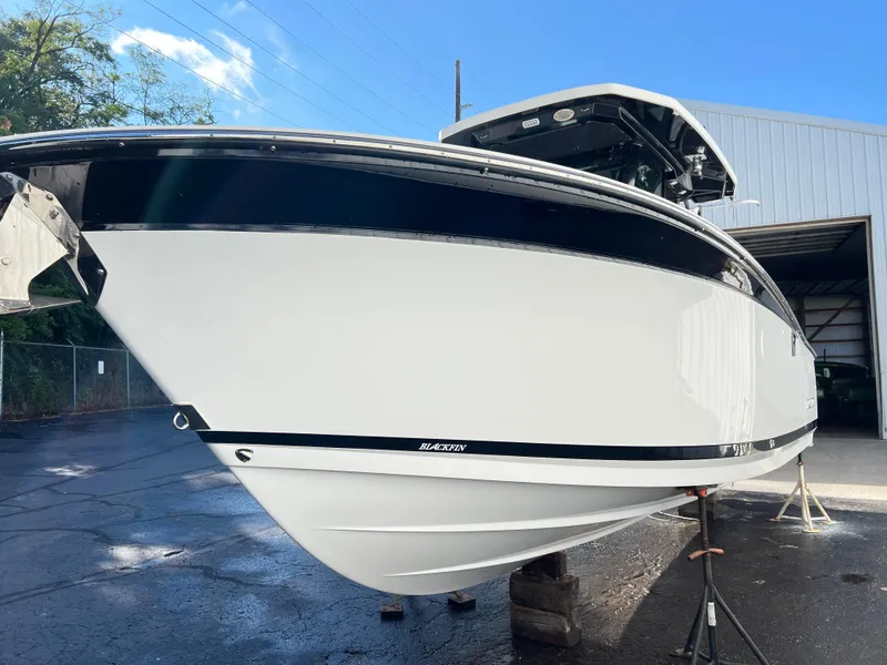 Slide: The Image of 2020 Blackfin 272 CC boat in a marina, showcasing sleek design and modern features. - 36