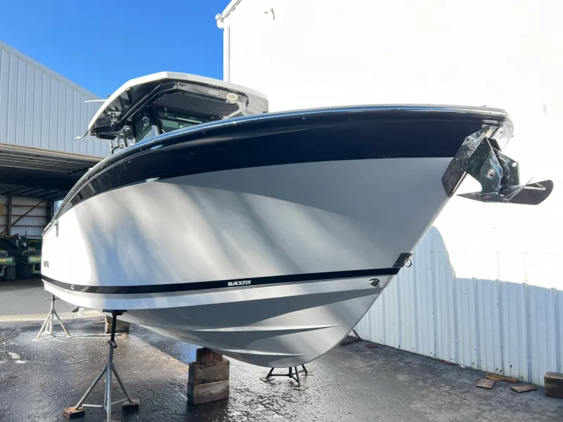 Slide: The Image of 2020 Blackfin 272 CC boat on stands, outdoor storage, sunny day. - 37
