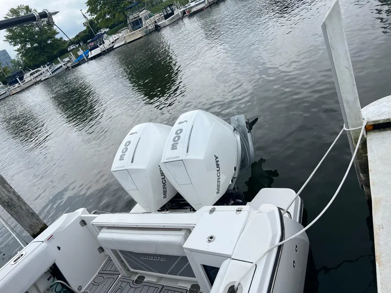 Slide: The Image of 2020 Blackfin 272 CC boat with twin Mercury outboard engines docked at marina. - 4