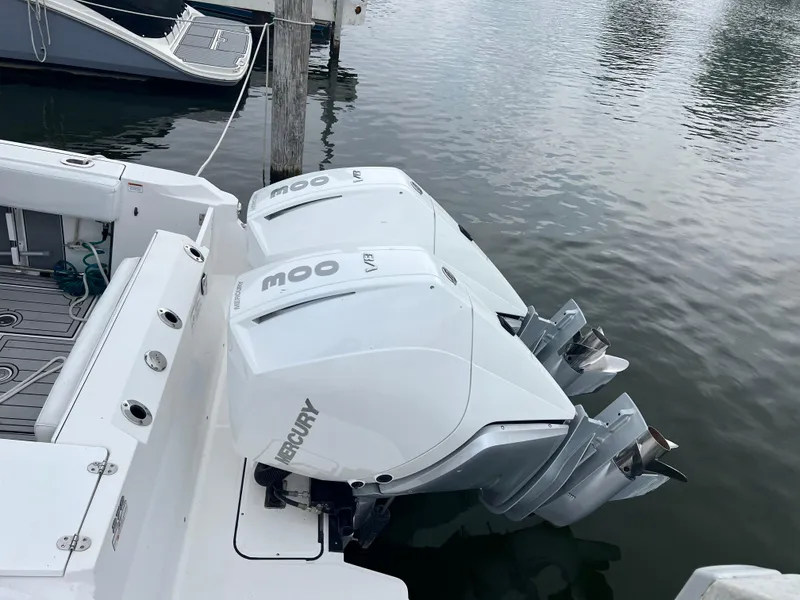 Slide: The Image of 2020 Blackfin 272 CC boat with twin Mercury outboard engines docked on calm water. - 5