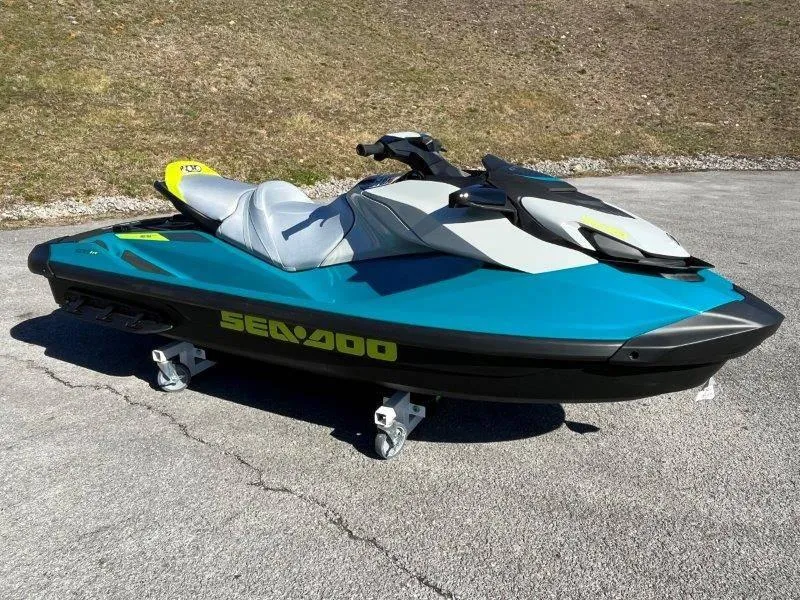 Slide: The Image of 2024 Sea-Doo GTI SE 130 IBR jet ski on pavement, vibrant blue and black design. - 10
