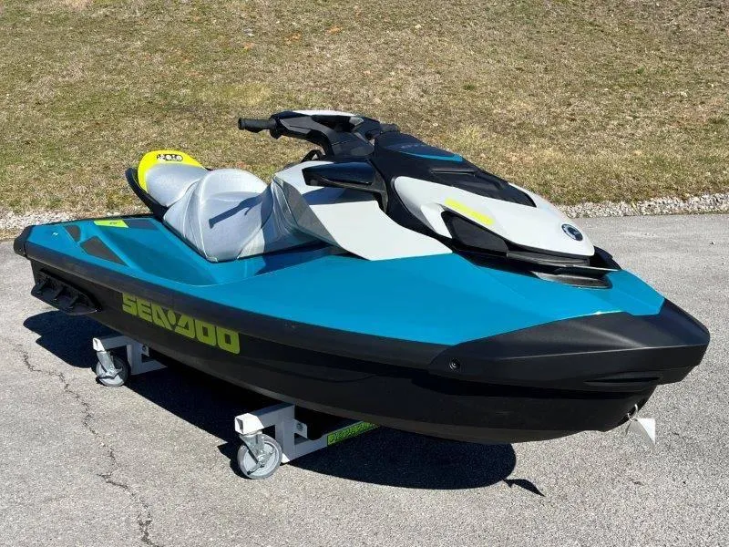 Slide: The Image of 2024 Sea-Doo GTI SE 130 IBR jet ski in blue and white on pavement. - 11