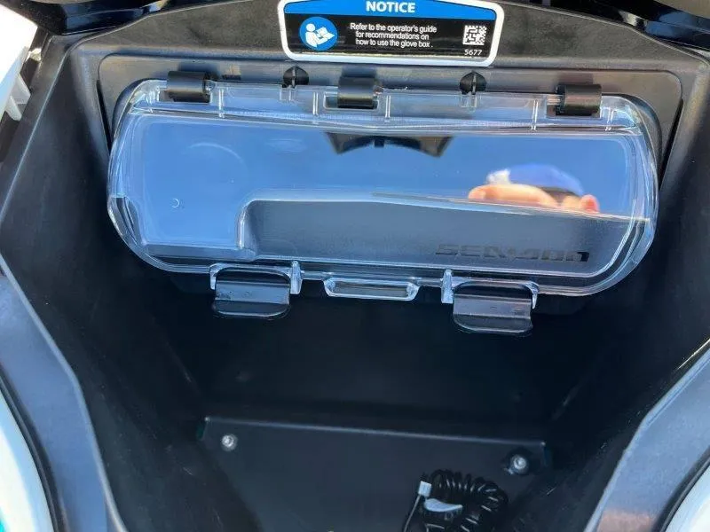 Slide: The Image of 2024 Sea-Doo GTI SE 130 IBR glove box with clear cover and notice label. - 20