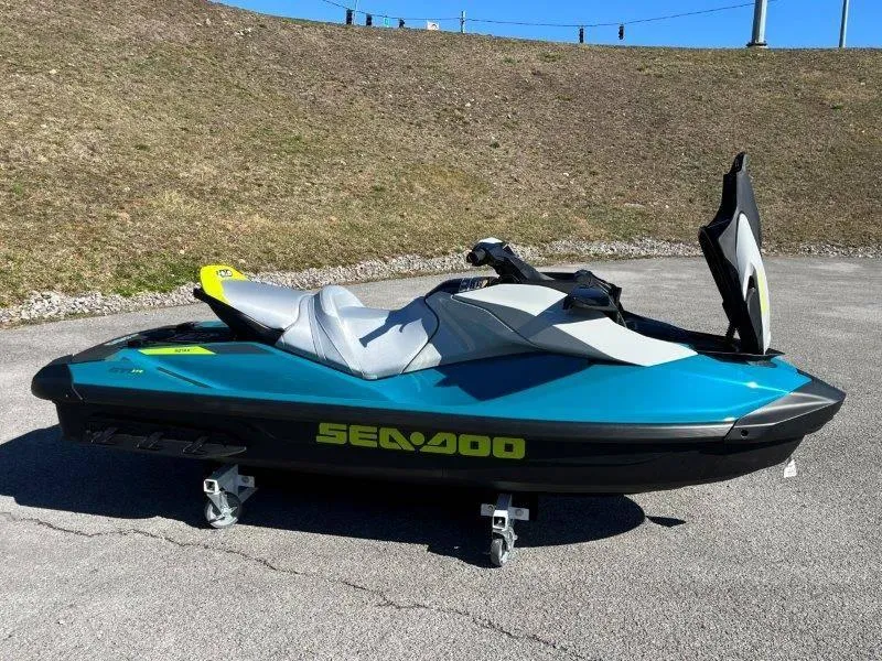 Slide: The Image of 2024 Sea-Doo GTI SE 130 IBR jet ski in blue on pavement. - 21